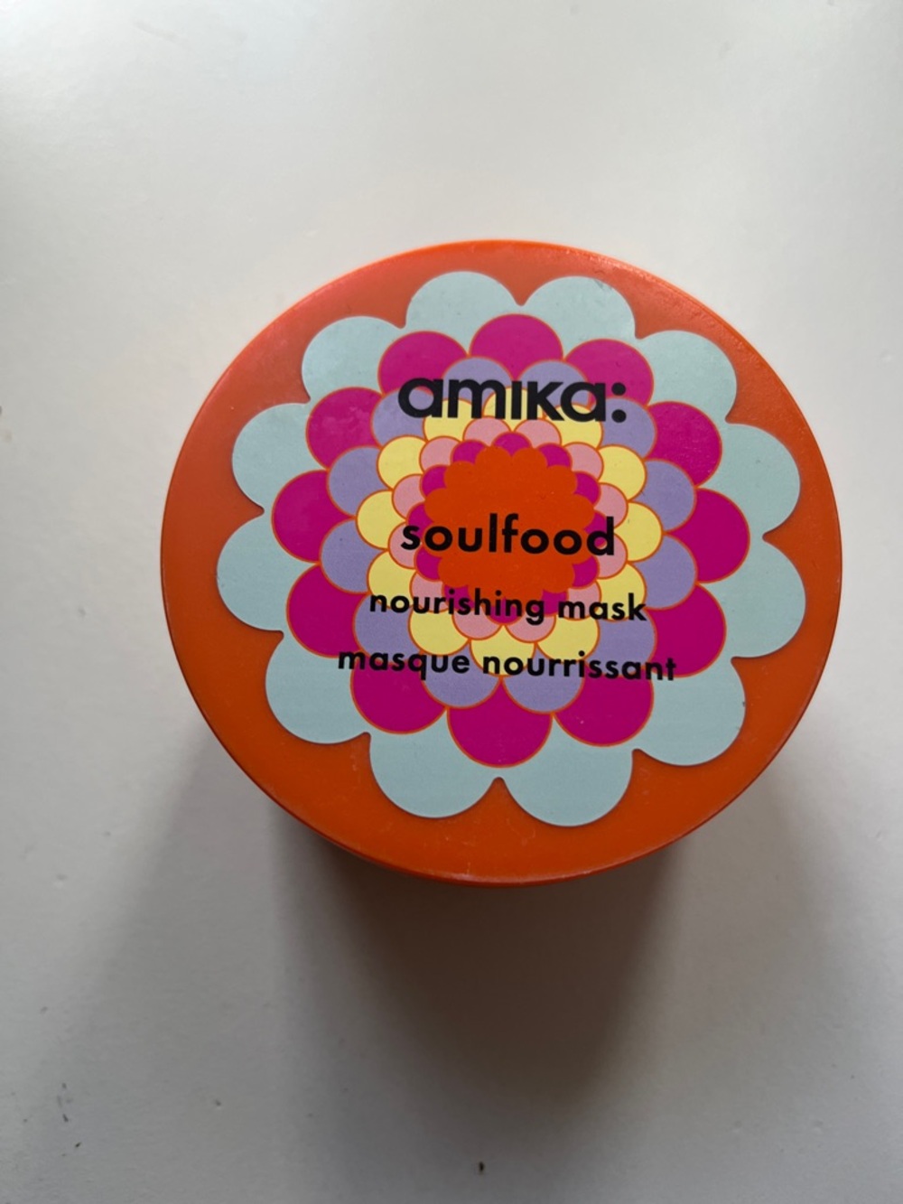 amika Orange Jar with Pink and Light Blue Floral Lid. Brand new